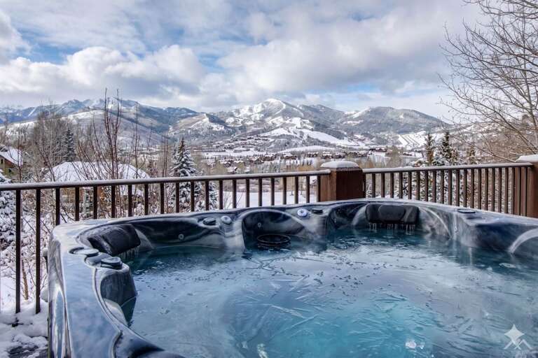 Soak in the hot tub and take in breathtaking mountain views after a day on the slopes. This private deck offers the perfect winter escape.