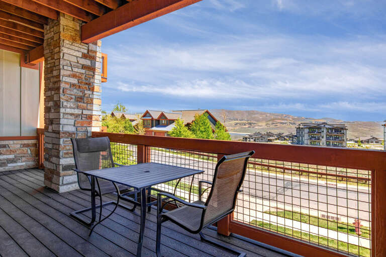 Private balcony featuring mountain views and a dining table perfect for morning coffee or evening relaxation under the covered patio.