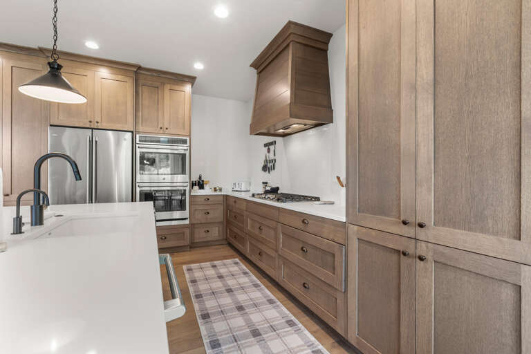 Your spacious gourmet kitchen features warm wood cabinetry, stainless steel appliances, and plenty of counter space for preparing meals together during your stay.