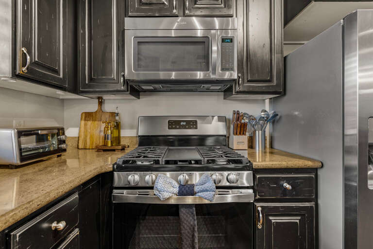 Your fully-equipped kitchen awaits, featuring sleek stainless steel appliances and ample counter space for preparing your favorite meals during your stay.
