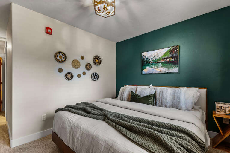 Sink into crisp linens on your plush king bed, surrounded by soothing earth tones and artful touches that invite you to unwind and recharge.