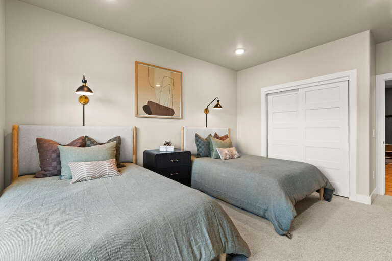 Sink into soft linens and rest easy in this thoughtfully designed twin bedroom, where warm wood accents and elegant lighting create a peaceful haven for your stay.