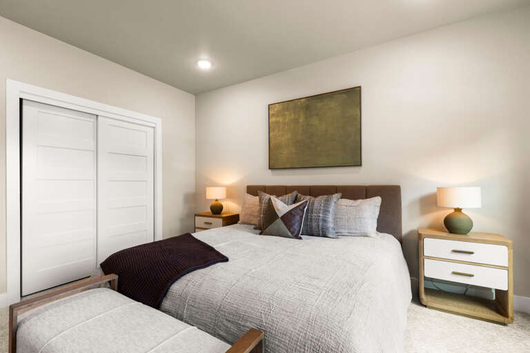 Sink into crisp linens and plush pillows in your peaceful bedroom retreat, where warm lighting and modern design create the perfect space to unwind after a day of adventure.