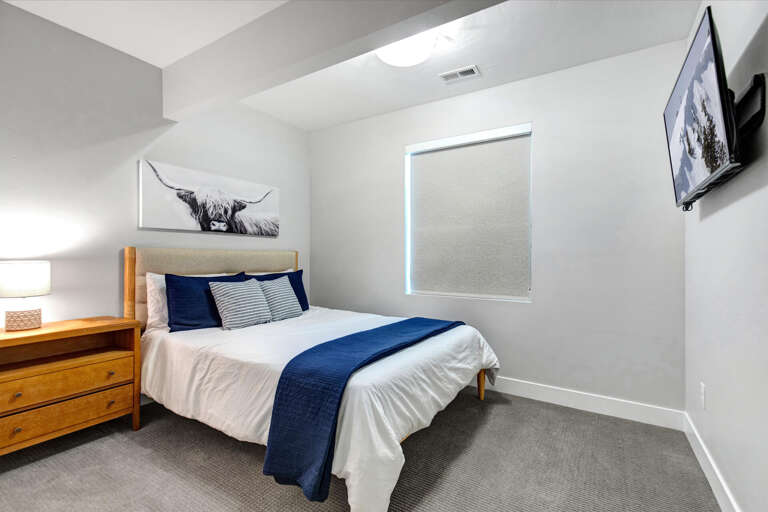 Settle into your serene bedroom, where crisp linens and contemporary décor invite restful nights after exploring the area.