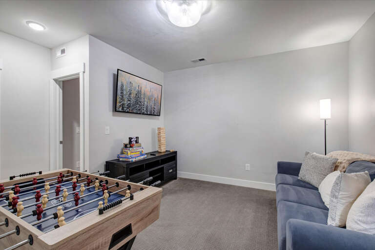Gather for friendly competition at the foosball table or settle in on the plush sofa for movie night. This inviting game room offers the perfect spot to unwind and enjoy quality time together.