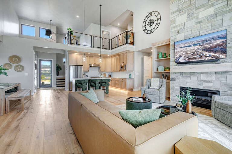 Stunning open-concept space with soaring ceilings and natural light. Relax by the cozy fireplace, gather at the stylish kitchen island, or simply soak in the modern elegance.