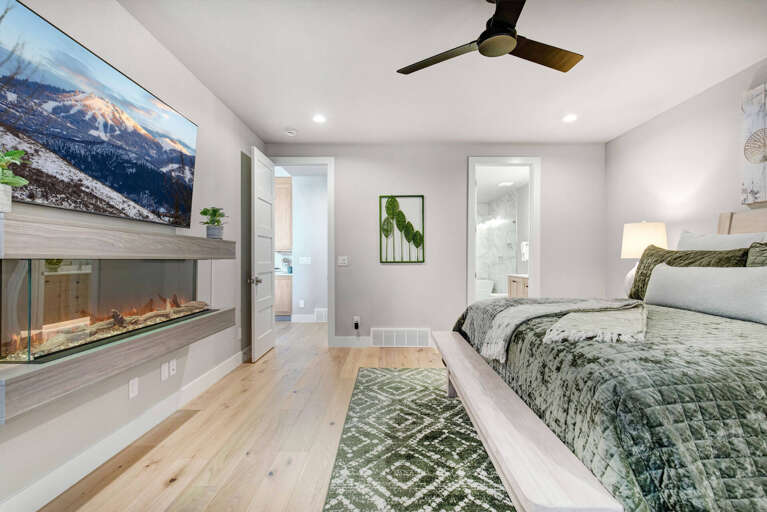 Unwind in your serene bedroom suite with a cozy fireplace and private ensuite bath. Soft lighting and modern comfort create the perfect retreat after a day of mountain adventures.