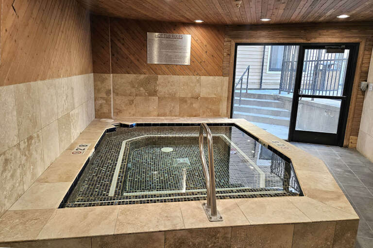 The property features an indoor hot tub with easy access steps and handrails, available for your relaxation throughout your stay.