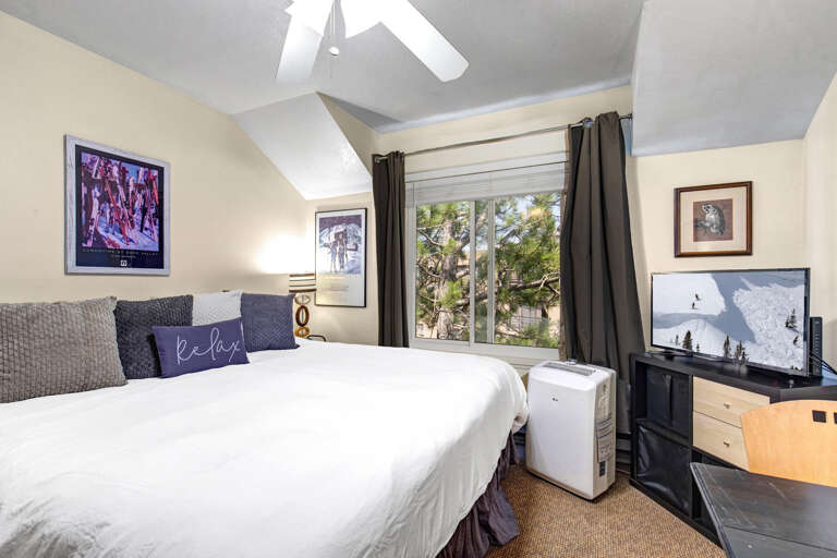 Slip into crisp white linens and let the vaulted ceilings and natural light create your peaceful retreat, with views of greenery right outside your window.