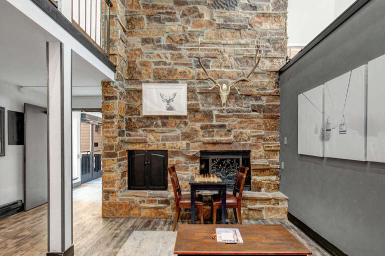 Unwind beside the towering stone fireplace, where rustic charm meets cozy alpine comfortâperfect for game nights and warm gatherings after a day of adventure.