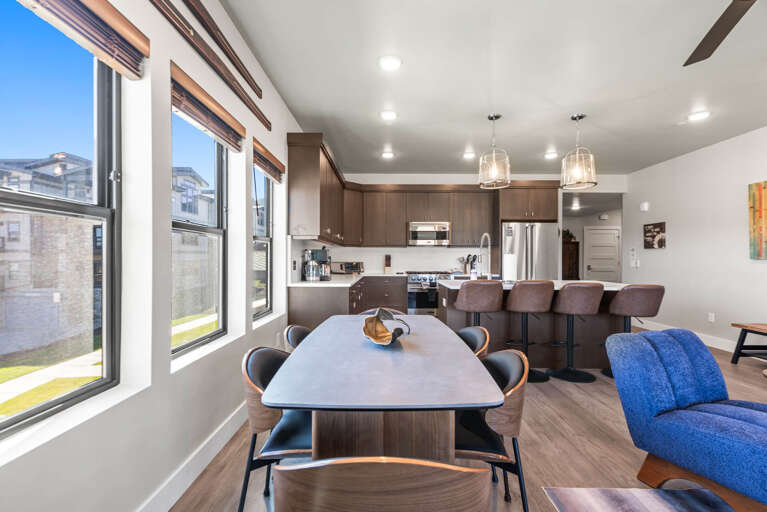 Gather with loved ones in your open-concept living space, where natural light pours through tall windows and a fully equipped kitchen awaits your culinary adventures.