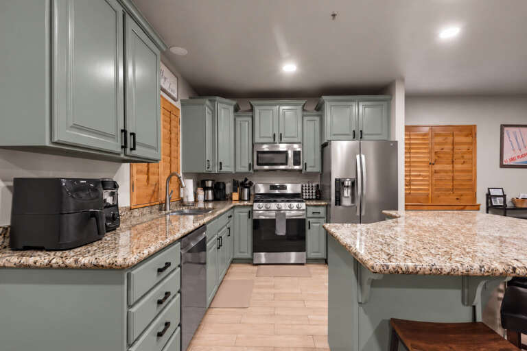 Your spacious gourmet kitchen features granite countertops, stainless steel appliances, and ample cabinet space—perfect for preparing memorable meals during your stay.