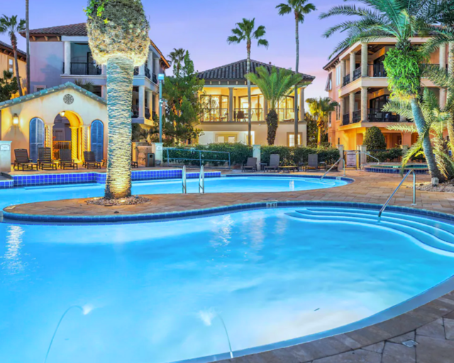 The lagoon style pool has a waterfall feature, outdoor shower, lounge chairs, dining tables, heated whirlpool spa, and outdoor bathrooms. Stunning!