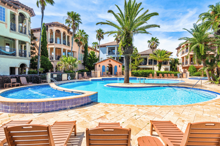 The lagoon style pool has a waterfall feature, outdoor shower, lounge chairs, dining tables, heated whirlpool spa, and outdoor bathrooms. Stunning!