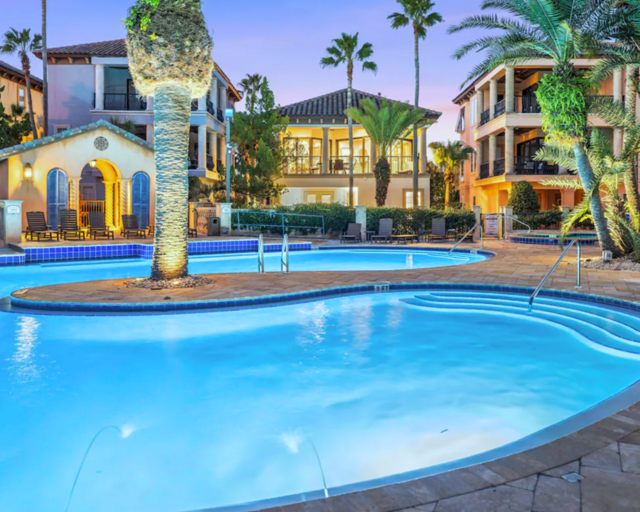 The lagoon style pool has a waterfall feature, outdoor shower, lounge chairs, dining tables, heated whirlpool spa, and outdoor bathrooms. Stunning!