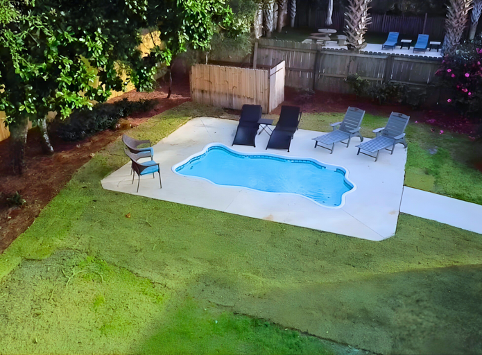 Poolside Patio With Loungers And Lush Lawn