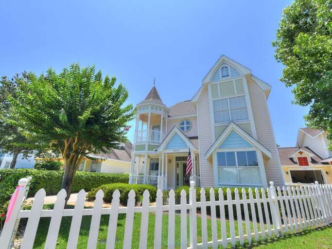 Victorian-style House With White Picket Fence