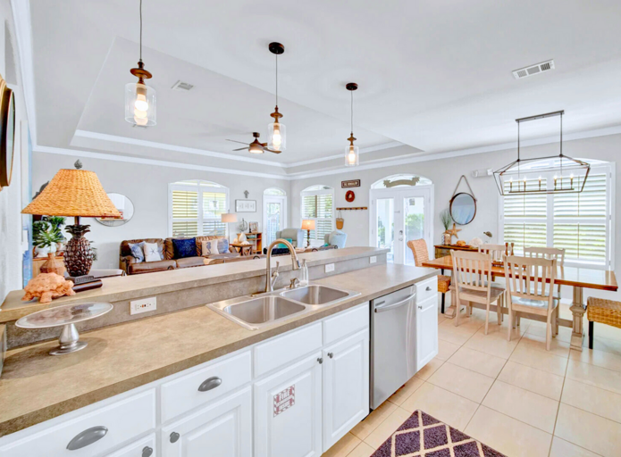 Gourmet Kitchen: Fully equipped with stainless steel appliances and a coastal-inspired backsplash.