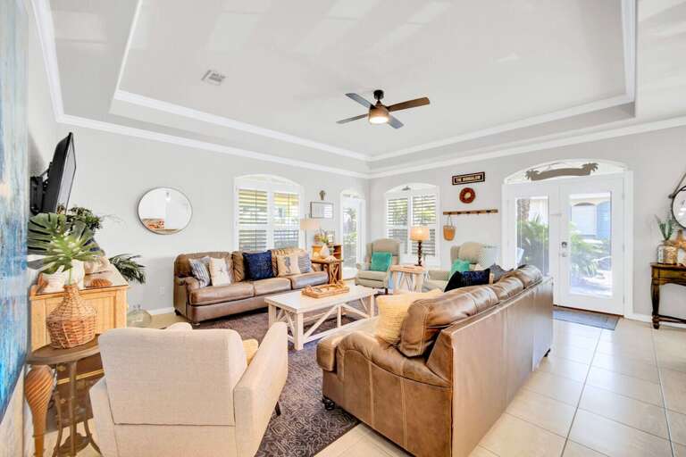 Open Living Area: Cozy seating with a smart TV and coastal decor.
