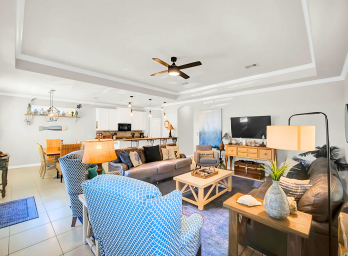 Open Living Area: Cozy seating with a smart TV and coastal decor.