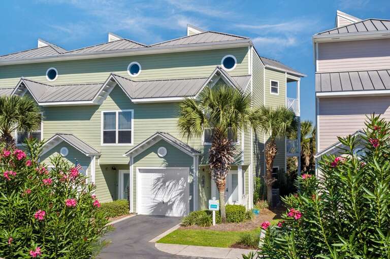 Green Vacation Townhouse Under Clear Blue Sky