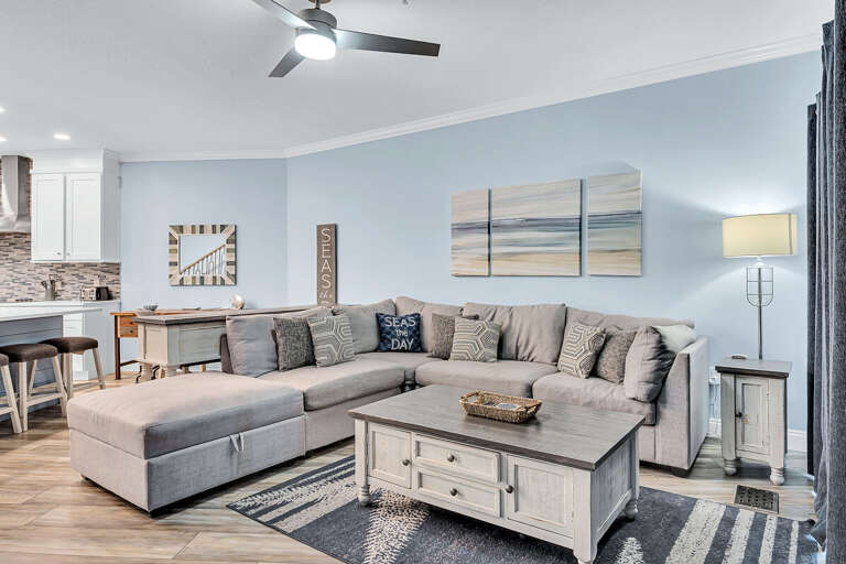 Interior Of A Vacation Rental Living Room With Sectional Sofa And Open Kitchen