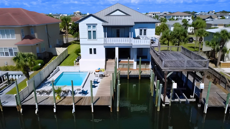 Welcome to Sandy Feet Retreat! Private Pool Overlooking canal, Private Dock & Boat Slip, Jet ski davit, Game Room, Balcony, Deck with BBQ Grill