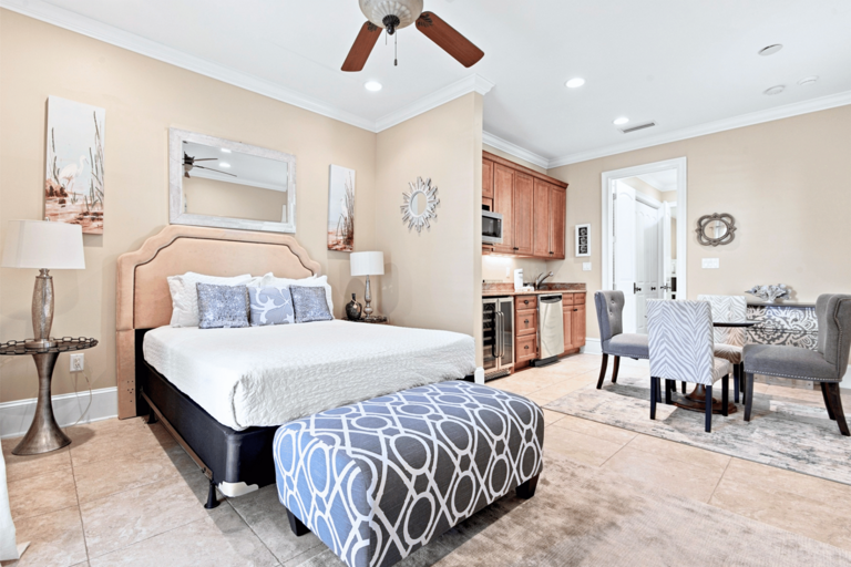 Studio Apartment 🛏️ Queen Bed (Sleeps 2) with refrigerator, microwave, dishwasher, sink, and sitting area.
