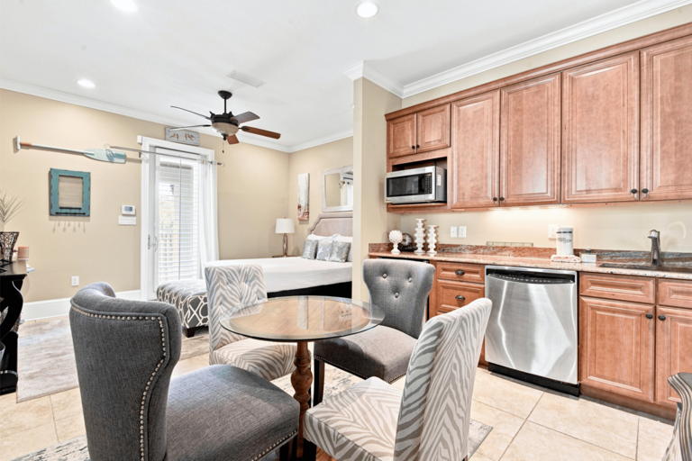 Studio Apartment 🛏️ Queen Bed (Sleeps 2) with refrigerator, microwave, dishwasher, sink, and sitting area.