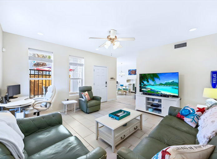 🛋️ Cozy den with pullout sofa, coastal décor and working desk