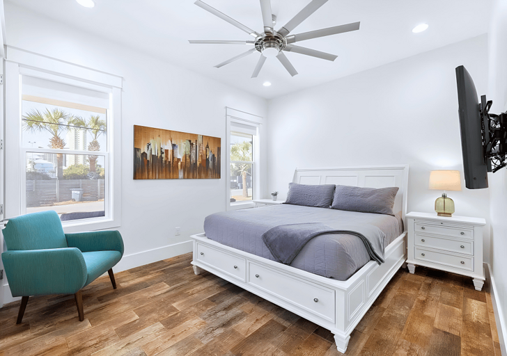 1st floor elegant Bedroom #1 with a king bed has a mounted flat-screen T