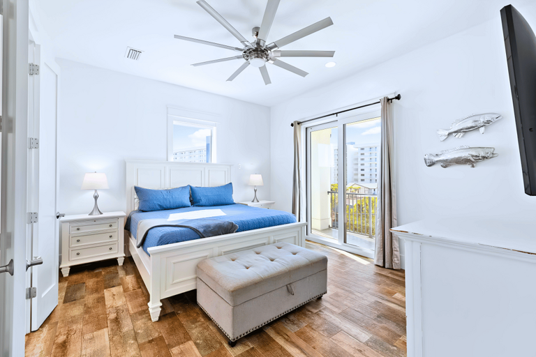 3rd floor luxurious Bedroom #7 with a king bed has balcony access and a flat-screen TV.