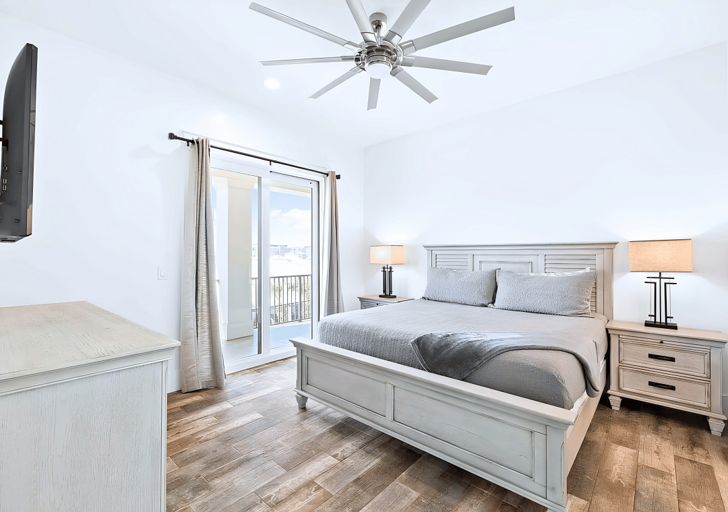 3rd floor modern Bedroom #6 with a king bed has balcony access and a flat-screen TV.