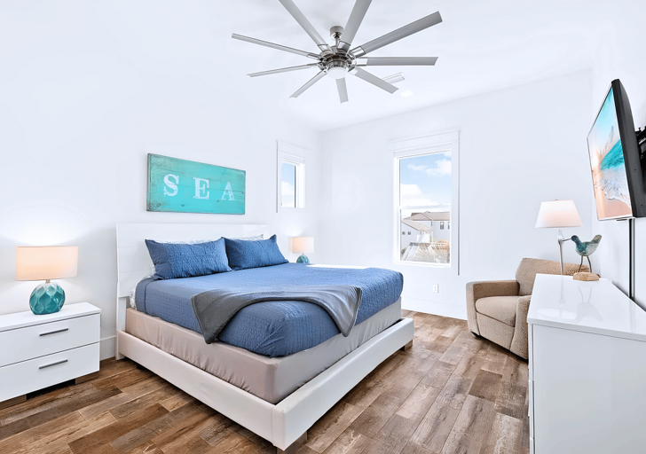 3rd floor sea-inspired Bedroom #8 with a king bed has a mounted flat-screen TV.