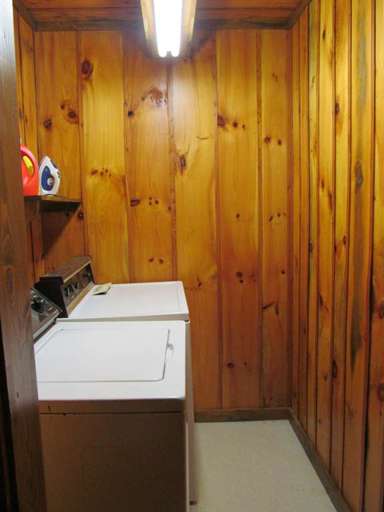 Wood-paneled Laundry Room With Washing Machine And Fluorescent Light Wood-paneled Laundry Room With Washing Machine And Fluorescent Light