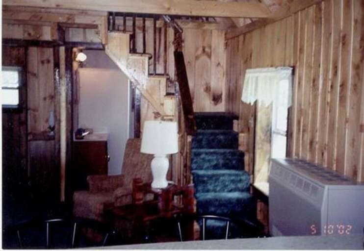 Wood-paneled Room With Staircase, Furniture, And A Television Wood-paneled Room With Staircase, Furniture, And A Television