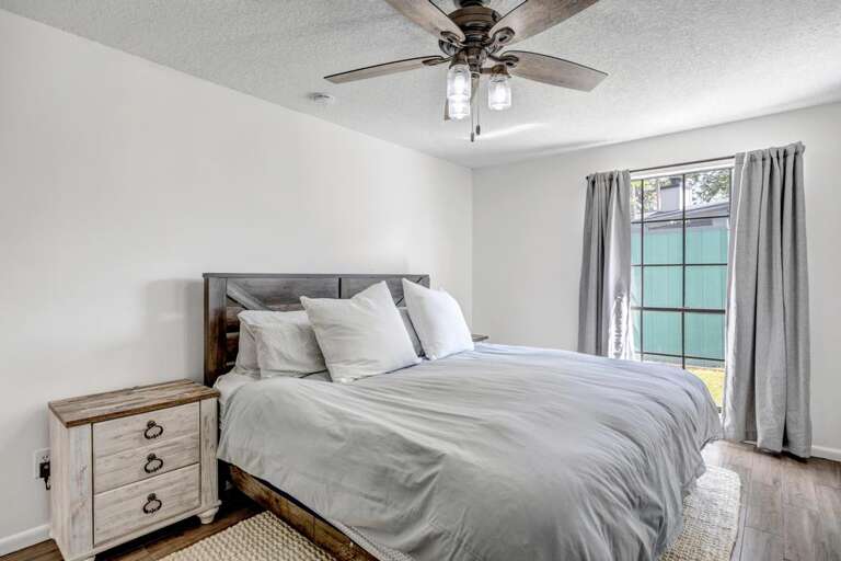 Spacious Bedroom, Sleek Ceiling Fan, Sliding Glass Doors