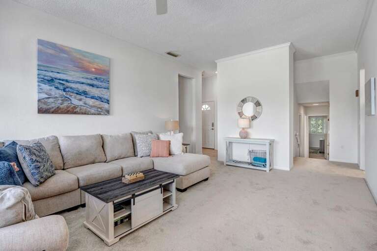 Spacious Living Space With Sofa And Sea-themed Painting