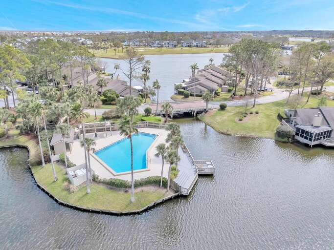 Aerial View Of A Lakeside Vacation Rental With Pool And Pier