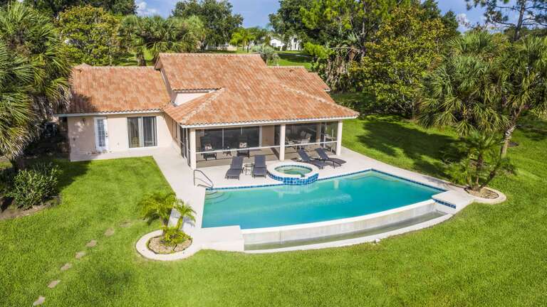 Single-story Residence With Swimming Pool Surrounded By Lush Greenery