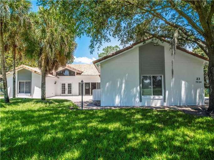 White Suburban House With Trees