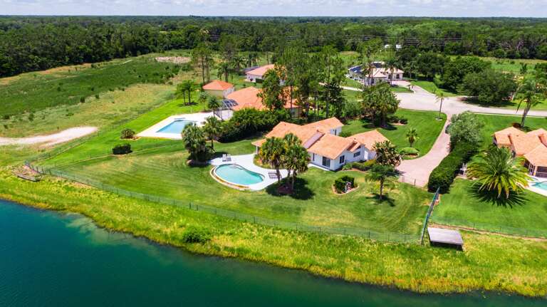 Aerial View Of Lakeside Lodgings With Lush Landscapes