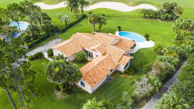 Aerial View Of A Spacious Vacation Rental With Pool And Lush Greenery