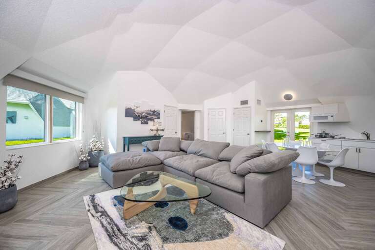 Spacious Living Area With Sofa And Open Kitchen In Vacation Rental
