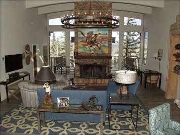 Large living room with brick fireplace and views!