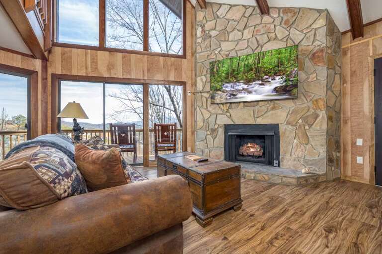 Wooden Walls, Stone Fireplace, Scenic View, Plush Seating, Large Windows