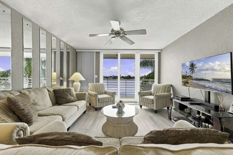 Spacious living area with coastal décor and natural light.jpg