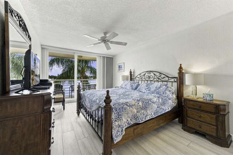Spacious primary bedroom with beautiful water views and private balcony access.jpg