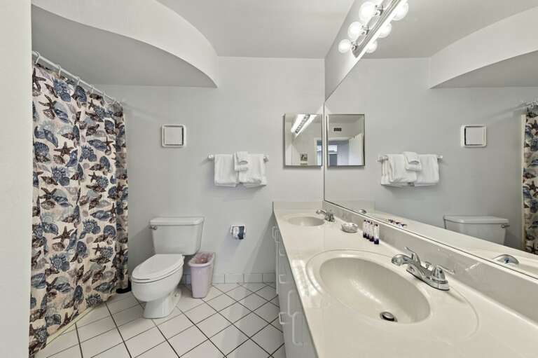 Bright primary bathroom with large vanity and plenty of counter space.jpg