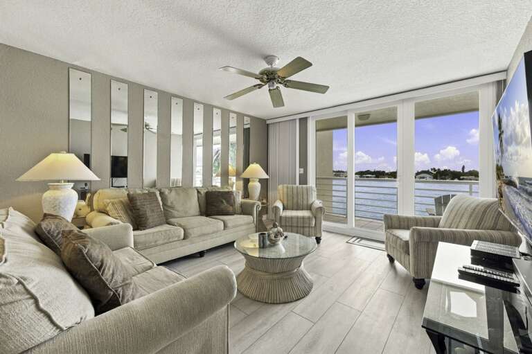 Comfortable living room with plenty of seating and water views.jpg